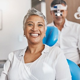 Woman smiling while sitting in treatment chair