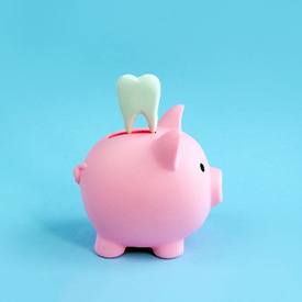 A pink piggy bank and a decorative tooth on a blue background