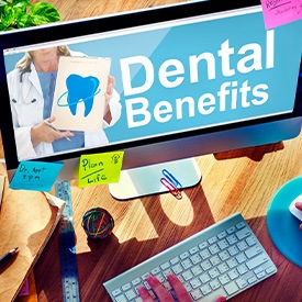 A man working at a computer monitor that reads ‘Dental Benefits’