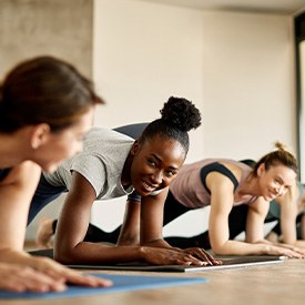 Group of women smiling during workout class