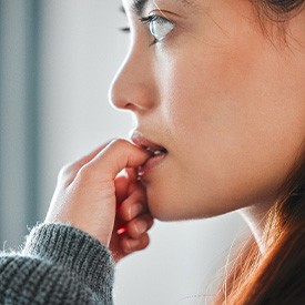 Closeup of woman biting their nails