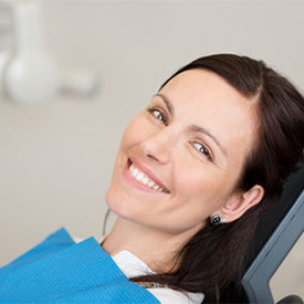 Woman happy in dental chair 
