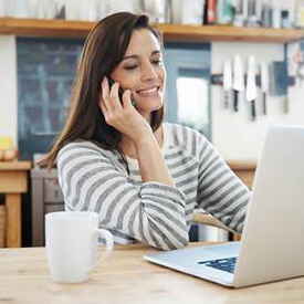 Smiling woman looking at laptop