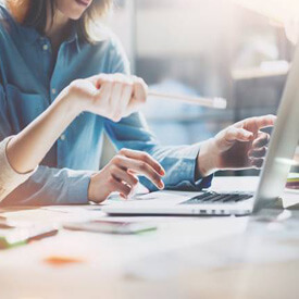 Smiling woman looking at laptop