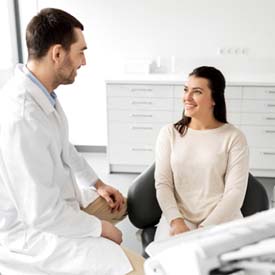 dentist talking to patient in Arnold