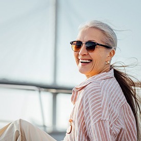 Woman smiling and enjoying the sea breeze from her boat