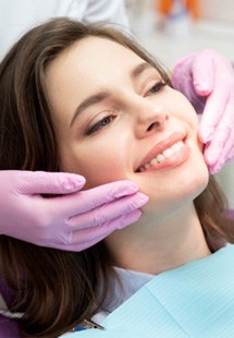 woman smiling after getting cosmetic dentistry 