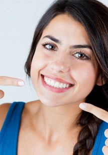 woman pointing to her smile 