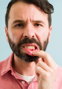 man pointing to bleeding gums 