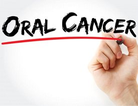 hand underlining “oral cancer” in marker