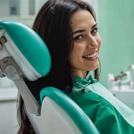 Smiling dental patient looking over her shoulder