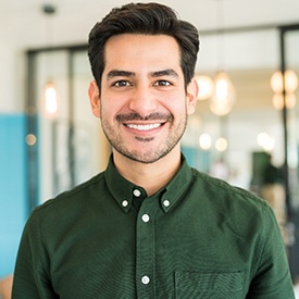 person standing and smiling in an office