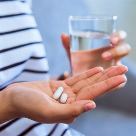 person holding pills in hand