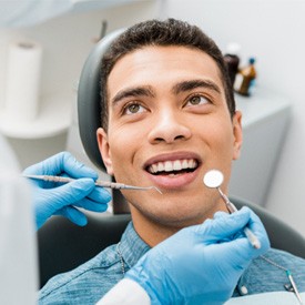 man smiling while looking at dentist