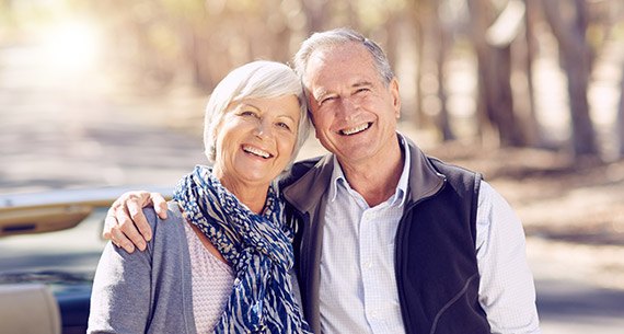 Senior couple smiling together outdoors