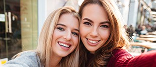 Two yougn women smiling together