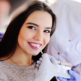 Woman getting veneers color matched to teeth