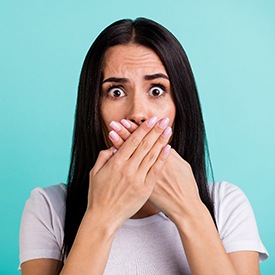 Woman covering her mouth with her hands