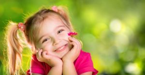  little girl smiling hands on face