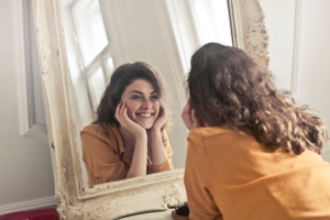 Woman looking at her smile in mirror