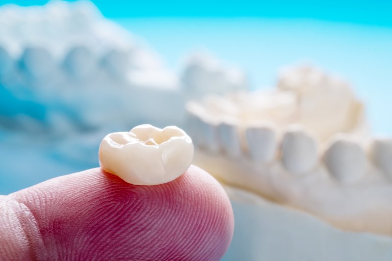 dental crown on person's finger