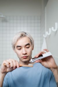 Man applying toothpaste to toothbrush